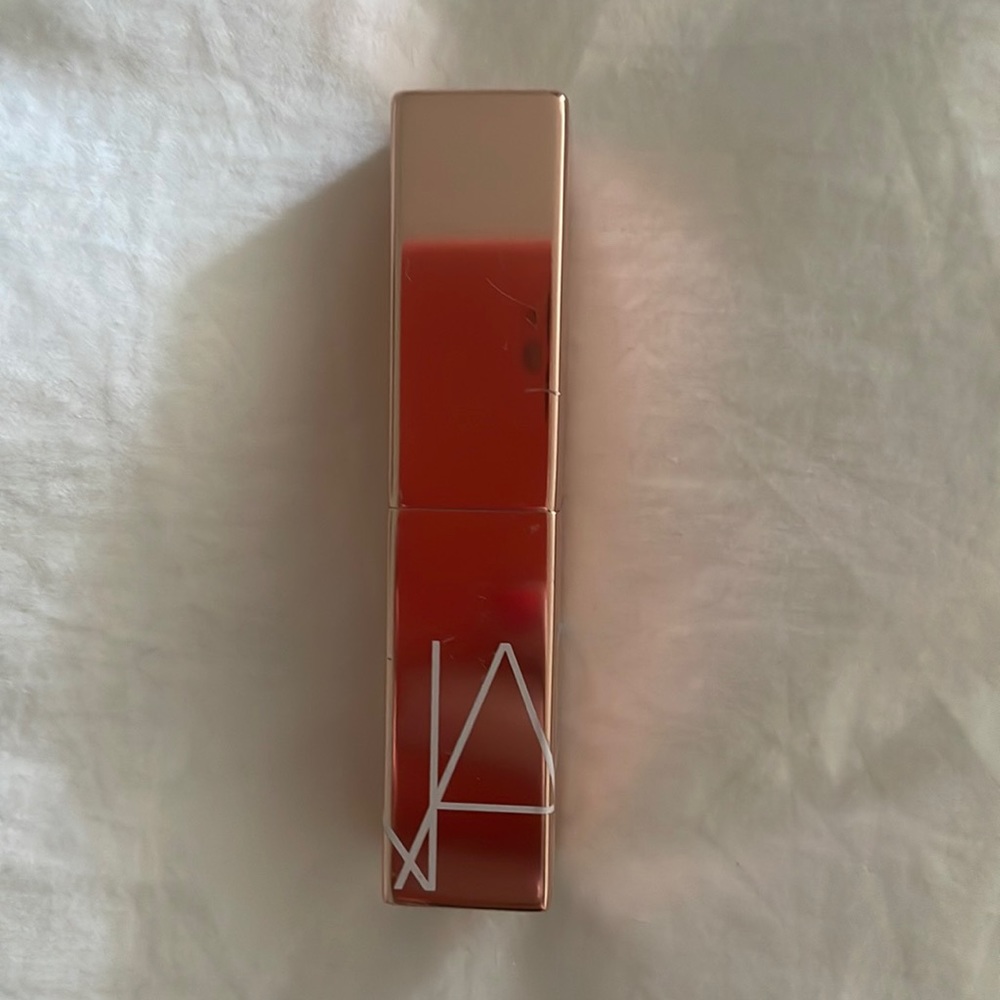 NARS afterglow lip balm in color orgasm, gently used